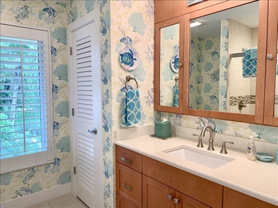 The guest bath has an oversized vanity, linen closet.