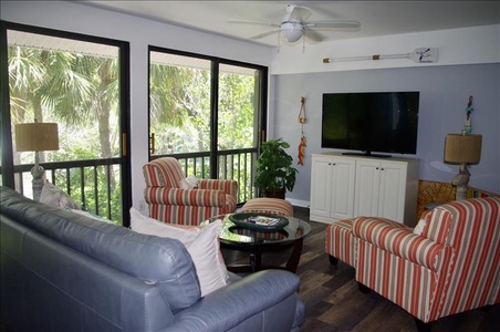 The sunroom has a Smart TV and beautiful garden views.
