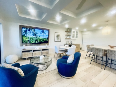 The living and dining area feature an oversized Smart TV.