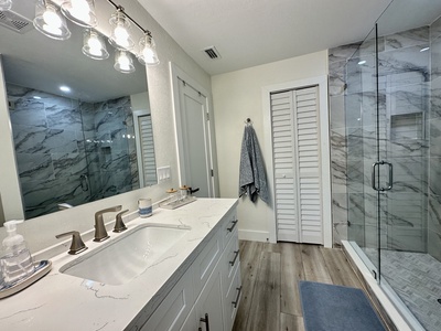 Oversized single vanity, custom shower, linen closet.