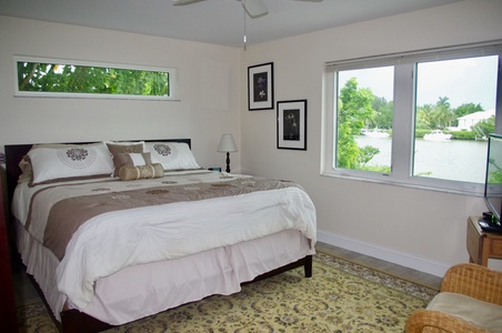 Primary bedroom with King bed has water views.