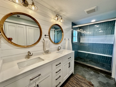 The primary bathroom has dual vanities and oversized shower.