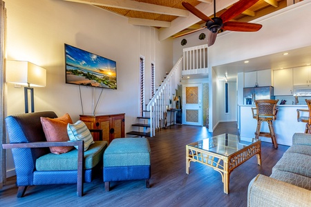 Relax in the spacious living room with vaulted ceilings and a cozy loft bedroom.
