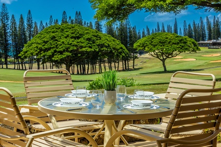 Private lanai with seating and open golf course views.