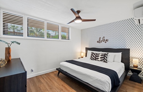 Primary bedroom features a cal king bed