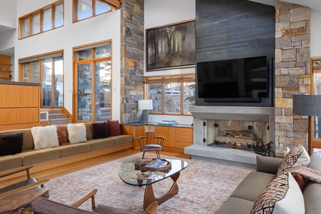 Stepped down living room with huge fireplace, smart TV, and views