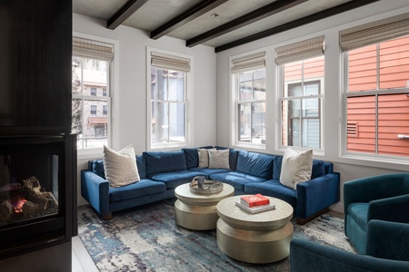 Great designer living room with gas fireplace, smart TV and ski area views