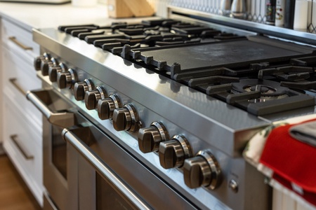 Professional gas range with multiple burners and spacious cooking surface