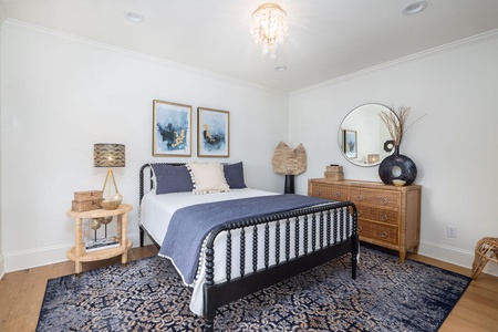 Your stylish queen bedroom features elegant, coastal-inspired decor