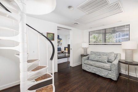 Walk past the spiral staircase to your living room