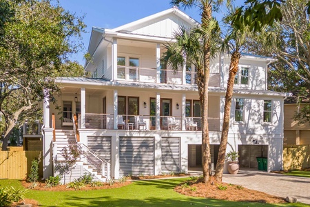 Welcome to Bikinis and Martinis, a coastal beach house with a contemporary design and tropical landscaping