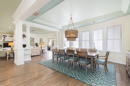 Gather for meal times under the recessed ceiling and woven chandelier