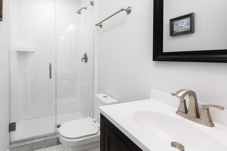 The queen bedroom features an en suite bathroom with walk-in shower