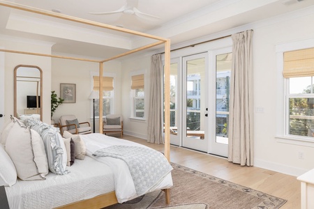 Step into your serene bedroom sanctuary with natural light streaming through expansive windows and doors opening to your private balcony.