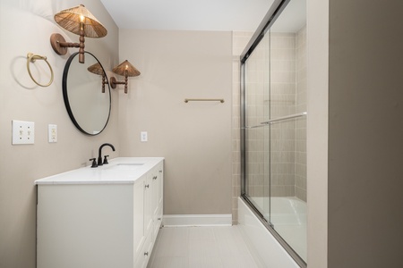 The hallway bathroom has been updated to include a glass walk-in shower