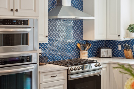 Your kitchen features a professional range and an elegant blue tile backsplash