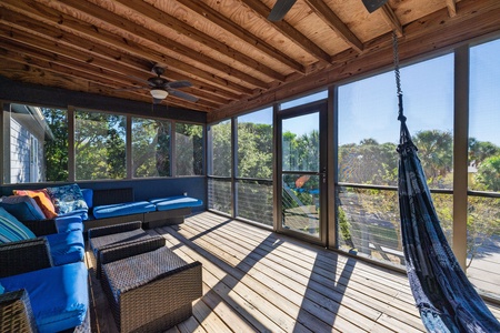 Peaceful front porch with hammock and cozy seating — unwind in the shade and enjoy the easygoing Folly Beach atmosphere.