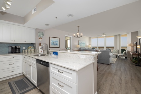 An open-concept kitchen provides views of the living space and Folly Beach beyond