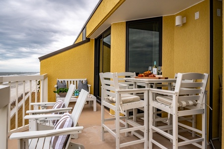 Your private beachfront terrace awaits with comfortable seating and dining space, where you can savor meals while watching waves roll in.