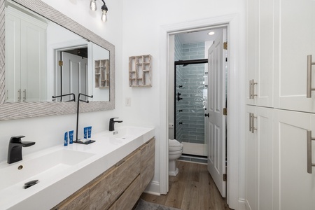 Your stylish bathroom features dual vanities with modern fixtures and a spa-like shower, perfect for morning routines.