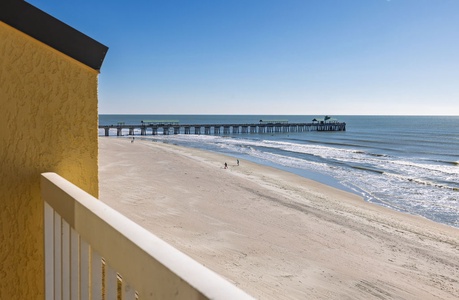 Step onto your private balcony and soak in stunning oceanfront views with direct beach access and a charming fishing pier stretching into crystal-clear waters.