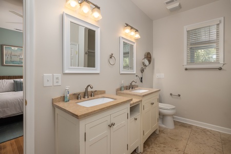 Your primary bathroom features a dual vanity and glass walk-in shower