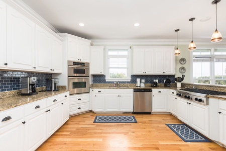 Enjoy preparing meals in this well-appointed kitchen with expansive counters and ocean breezes just steps away.