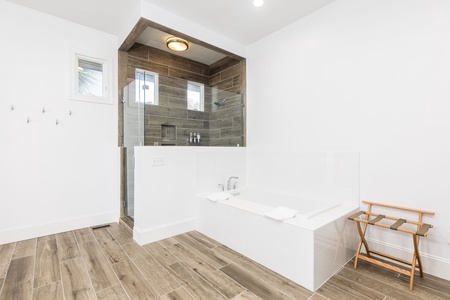 Your primary bedroom features an en suite bathroom with walk-in shower and large soaking tub