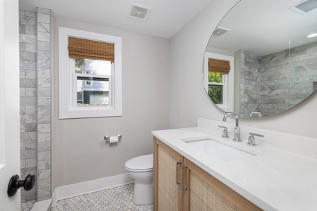 The primary bathroom has a walk in shower and large vanity