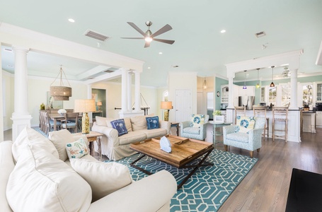Unwind in this bright open-plan space where coastal comfort meets modern style with plush seating and an inviting kitchen perfect for gathering.