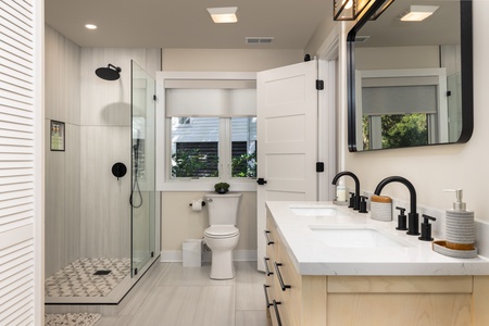 The queen en suite bathroom features a dual vanity and walk-in shower