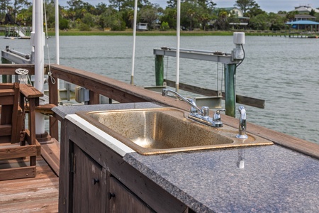 Serene waterfront setting with a private dock overlooking calm waters, offering a peaceful backdrop as part of the property's surrounding area.