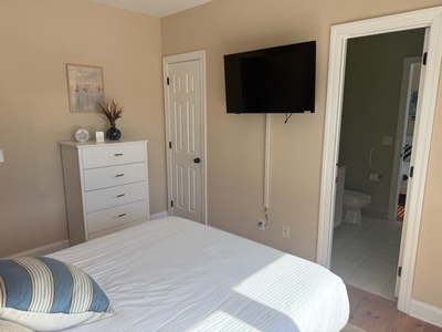 Your cozy bedroom features a comfortable bed, flat-screen TV, and convenient ensuite bathroom—perfect for peaceful nights and relaxing mornings.