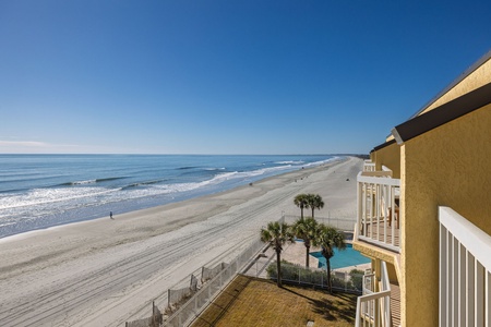 Oceanfront property with direct beach access, pool area, and stunning coastal views stretching along pristine sandy shoreline.