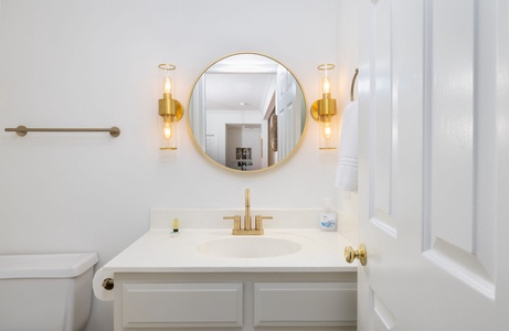 A stylish half bath with a modern vanity is located just off the living area