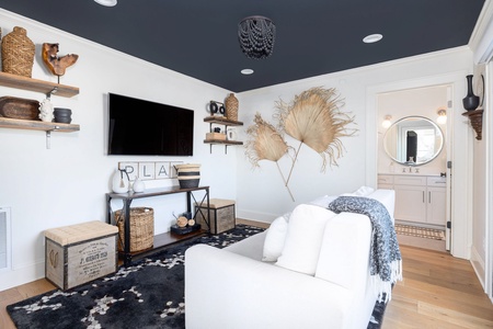 Unwind in your stylish living space with coastal-inspired decor, cozy seating, and modern amenities for the perfect relaxing retreat.