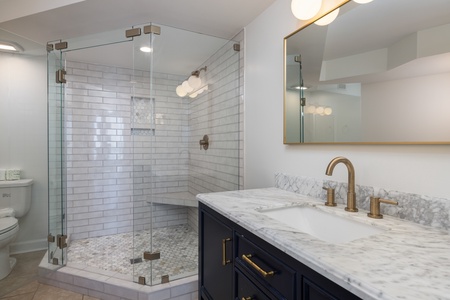 Your primary en suite bathroom has been beautifully renovated with a glass walk-in shower and dual vanity