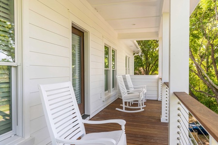 Listen to the birds and take in the coastal breeze on your upstairs balcony with large rocking chairs