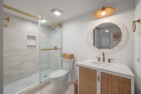 The second bathroom features a walk-in shower with sliding glass doors