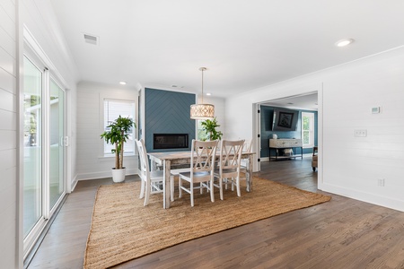 The dining room is perfect for family meals and features a modern fireplace