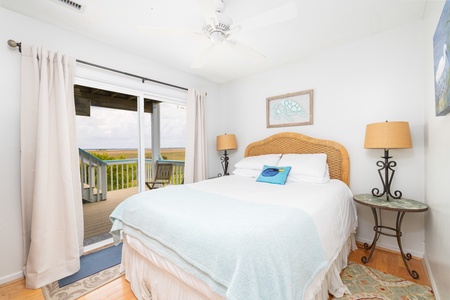 Wake up to marsh views from your first queen bedroom