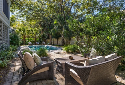 Catch some rays next to the pool on this cozy patio.