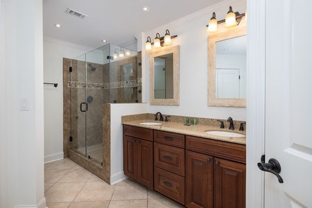 Your primary en suite bathroom features a dual vanity and walk-in shower
