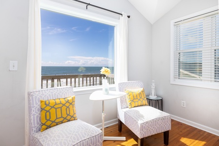 Settle into your cozy reading nook with a book and let the soothing ocean views wash over you through the window—a perfect little escape within your own space.