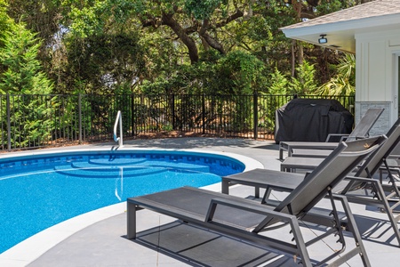 Easy Breezy features a sparkling backyard pool for relaxing al fresco