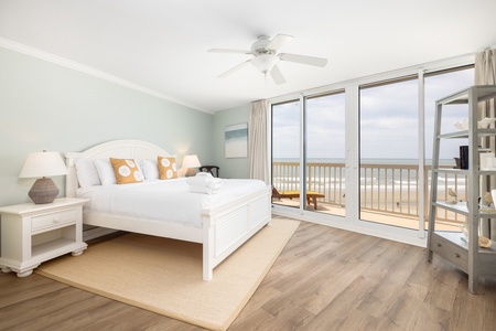 The primary bedroom features a king bed and stunning views from your glass sliding doors