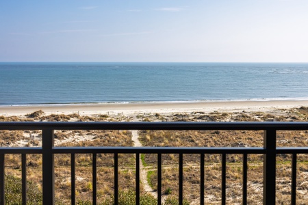 Breathtaking ocean panorama stretches endlessly from your private balcony, with golden sand and gentle waves just steps away from your door.