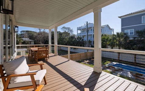 Unwind on your private covered deck with comfortable seating and dining space, surrounded by coastal neighborhood views.