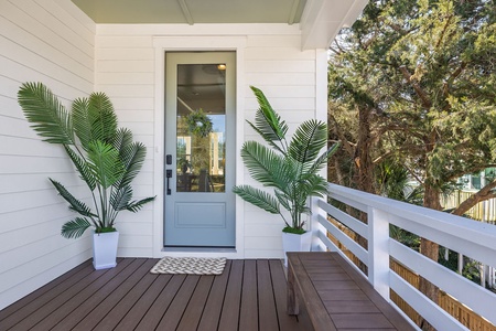 A welcoming entrance with tropical palms frames your arrival, setting a peaceful tone before you step inside.