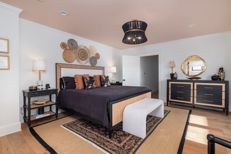 Your primary bedroom has a king sized bed, en suite bathroom, private workspace, and balcony